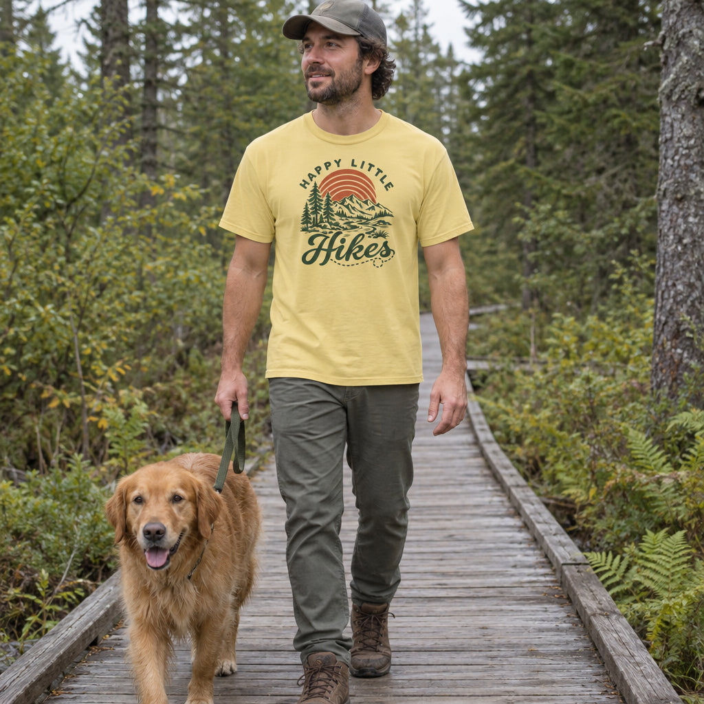 Man wearing the Happy Little Hikes T-Shirt on a forest boardwalk with a dog