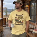Man wearing the Not a 5K Family Camp Chair Nap T-Shirt on a cabin porch