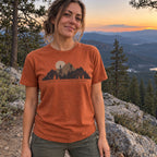 Woman wearing the Lookout Hours T-Shirt in Yam at a mountain overlook