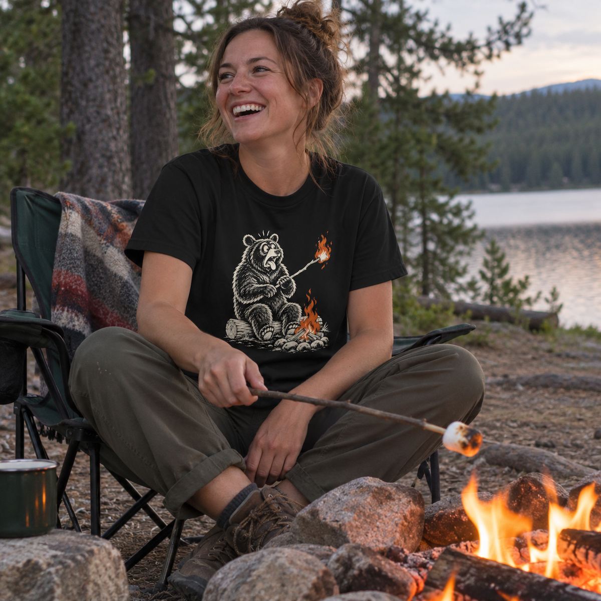 Woman roasting marshmallows wearing the Marshmallow Meltdown T-Shirt