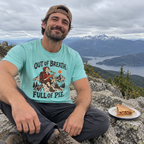 Man wearing the Out of Breath Full of Pie T-Shirt on a summit with a slice of pie