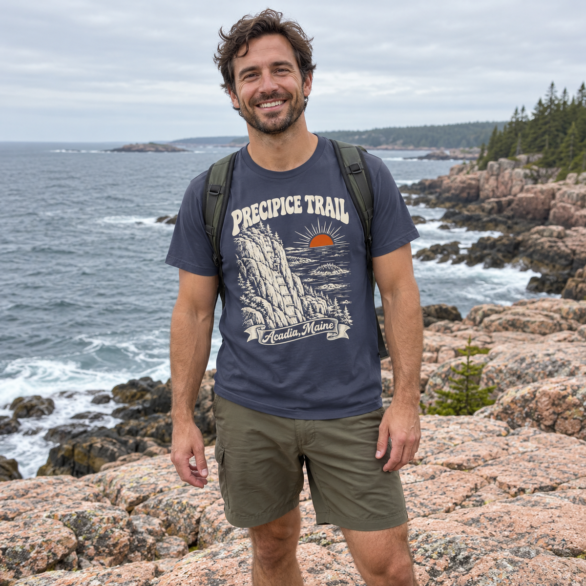 Man wearing the Precipice Trail T-Shirt on the Maine coast