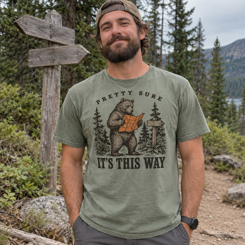 Man wearing the Pretty Sure It's This Way bear T-shirt at a trailhead