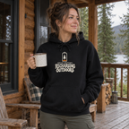 Woman wearing the Social Battery: Recharging Outdoors Hoodie on a cabin porch