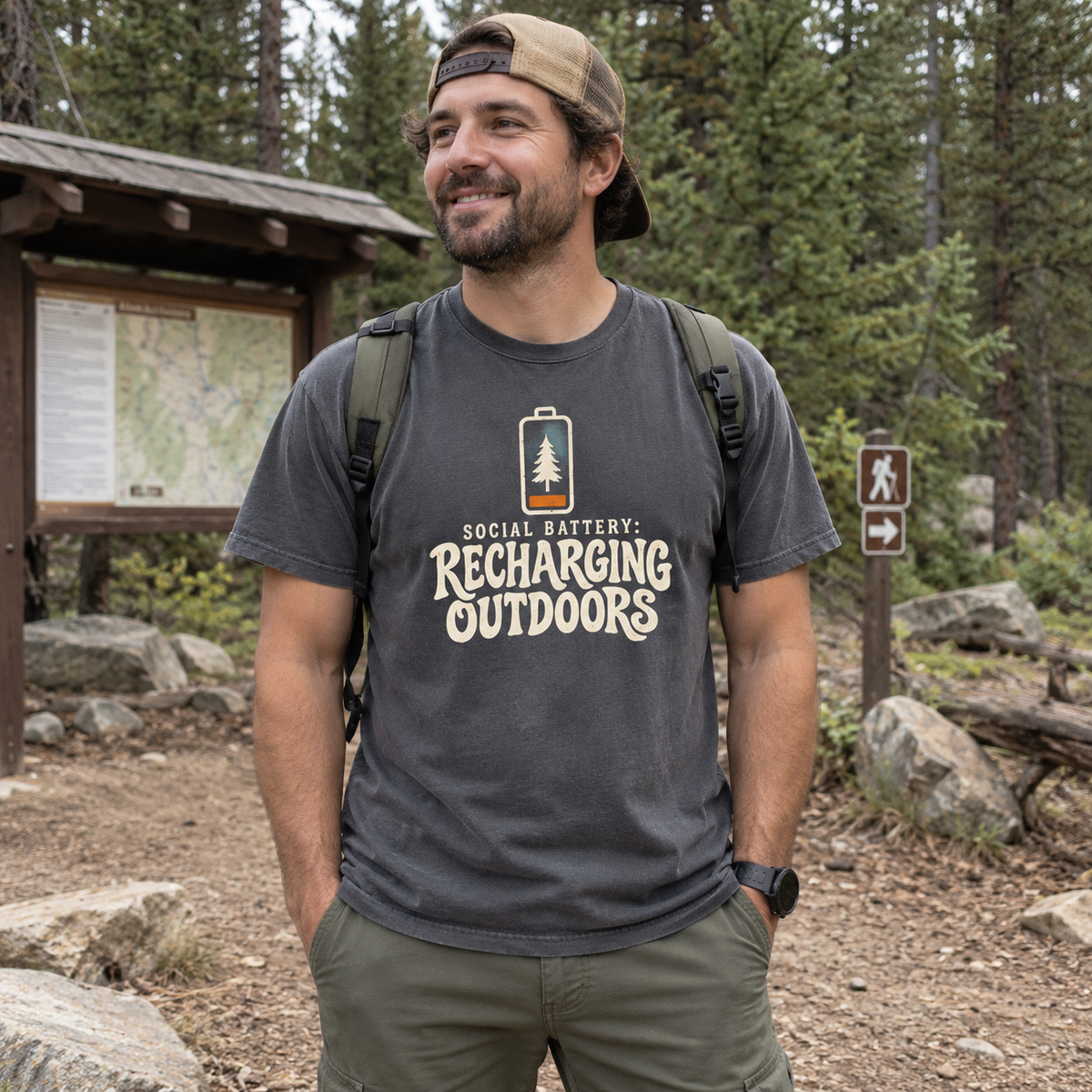 Man wearing the Social Battery: Recharging Outdoors T-Shirt on a trail