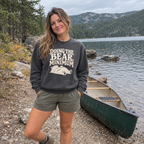 Woman wearing the Doing the Bear Minimum Sweatshirt outdoors