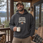 Man wearing the Weekend Forecast: 100% Chance of Campfire Hoodie on a cabin porch
