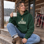 Woman wearing the Mildly Outdoorsy Hoodie on a cabin porch