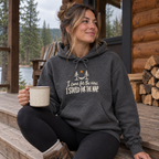 Woman wearing the I Came for the View. I Stayed for the Nap. Hoodie on a cabin porch