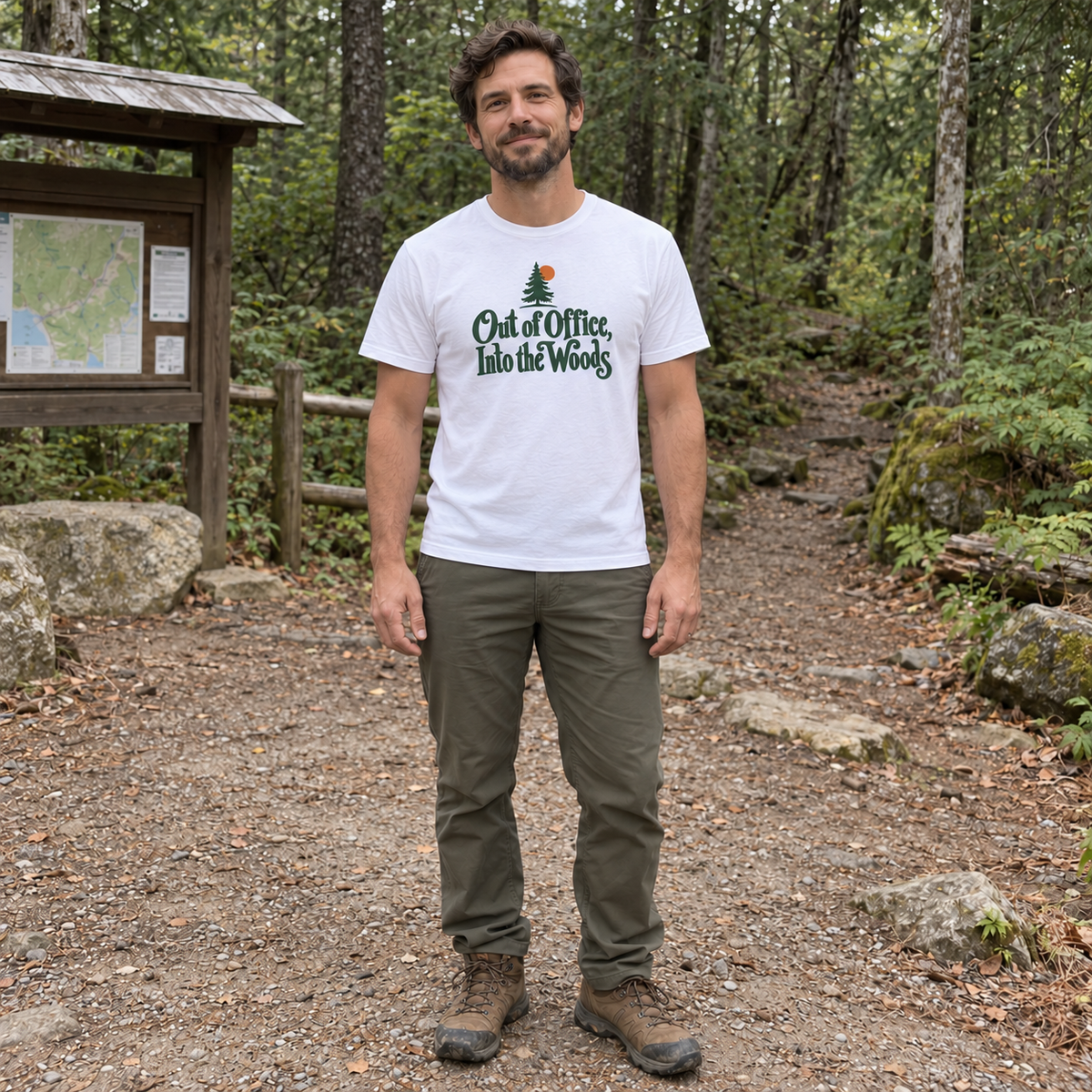 Man wearing the Out of Office, Into the Woods T-Shirt at a trailhead