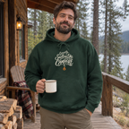 Man wearing the Currently Smelling Like Campfire Hoodie on a cabin porch
