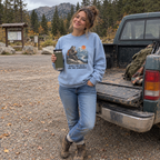 Woman wearing the chambray Hiked Two Miles for This Sandwich sweatshirt at a trailhead