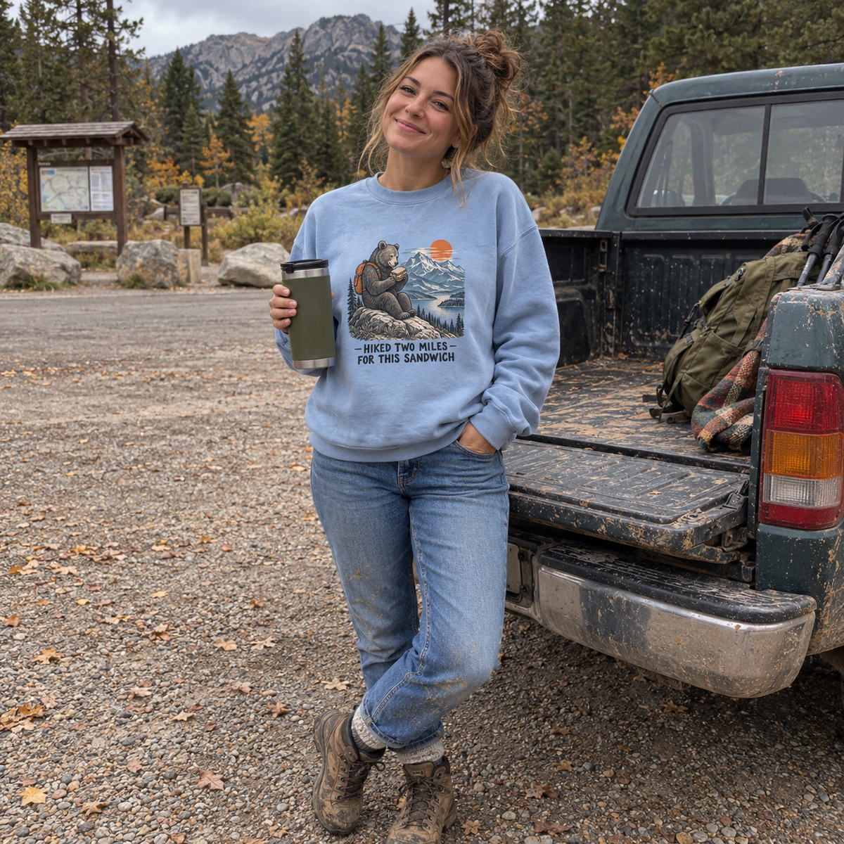 Woman wearing the chambray Hiked Two Miles for This Sandwich sweatshirt at a trailhead