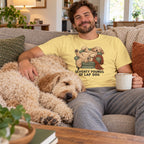 Man wearing the Seventy Pounds of Lap Dog T-shirt with a labradoodle asleep on his lap