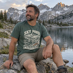 Man wearing the Sky Pond T-Shirt by an alpine lake