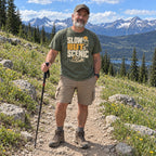 Man wearing the Slow but Scenic T-Shirt on a mountain meadow trail