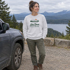 Woman wearing the Slow Down Out Here crewneck sweatshirt at a scenic pull-off by the car