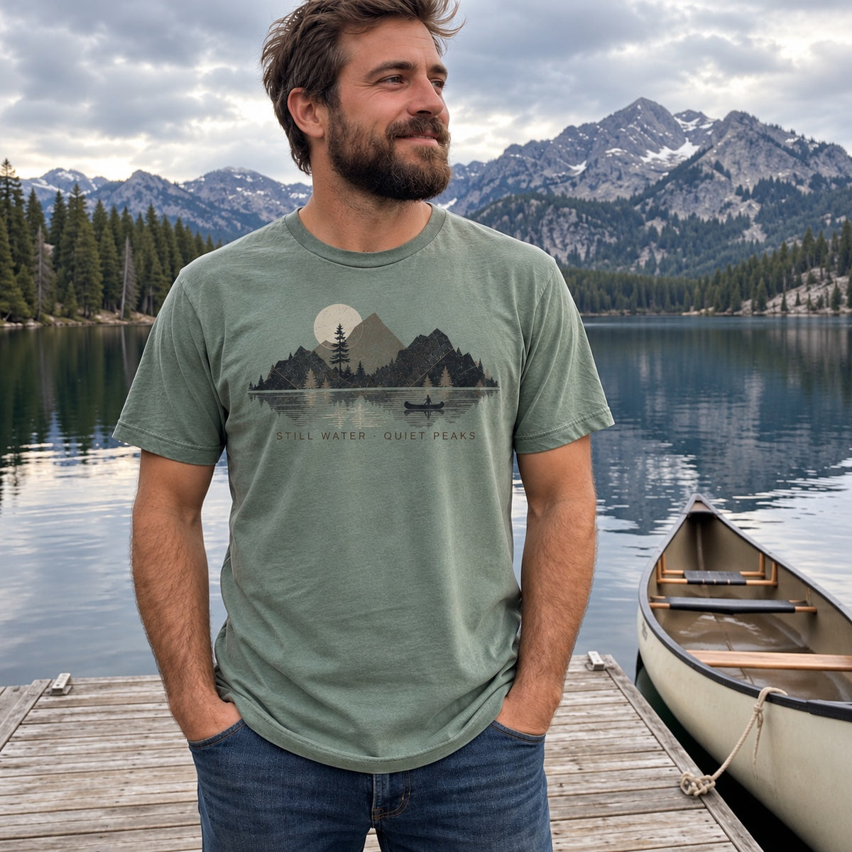Man wearing the Still Water Range T-Shirt in Bay on a lake dock