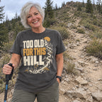 Woman wearing the Too Old for This Hill T-Shirt at the bottom of a steep trail