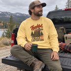 Man wearing the Thankful for Trails and Leftovers Sweatshirt on a truck tailgate