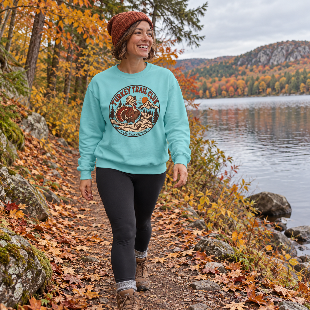 Woman wearing the Turkey Trail Club Sweatshirt on a lakeside trail