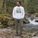 Man wearing the Out of Breath Hiking Society Sunset Long Sleeve Shirt by a forest creek