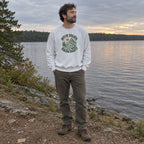Man wearing the Out of Breath Hiking Society Switchback Sweatshirt by a lake at dusk