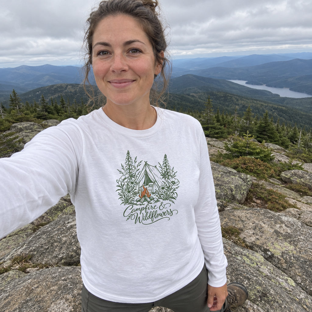 Woman wearing the Campfire & Wildflowers Long Sleeve Shirt taking a selfie on a mountain summit